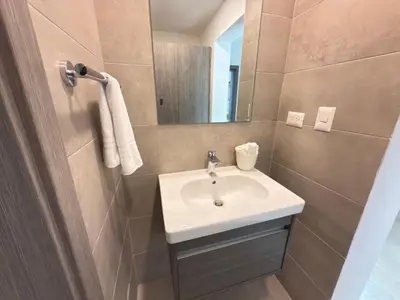 a bathroom with a sink and a mirror at Casa Mulata Paseo del Mar 2 Pool & Playa in Punta Cana