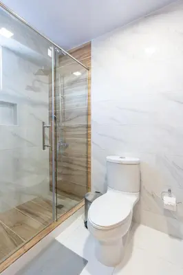 a bathroom with a toilet and a shower at Modern Oasis near Monument with Rooftop BBQ , Gym, and Free Parking in Santiago de los Caballeros