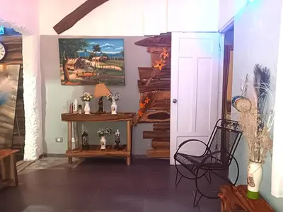 a room with a hallway with a table and a door at 1Vida Bar Restaurante in Guayacanes