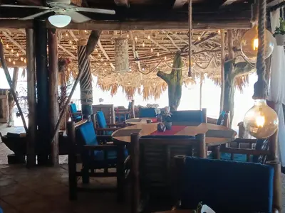 a restaurant with tables and chairs in a room at 1Vida Bar Restaurante in Guayacanes