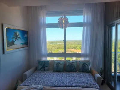 a bedroom with a bed in front of a window at Ventanas del mar in Los Corrales