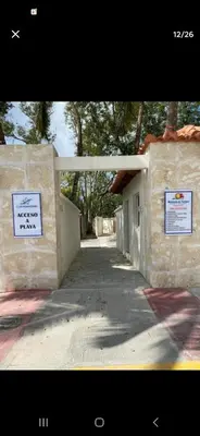 a building with two signs on the side of it at Ventanas del mar in Los Corrales