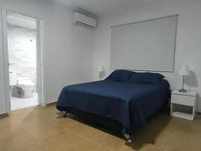 a bedroom with a bed and a bathroom with a toilet at Cana Esmeralda in Punta Cana