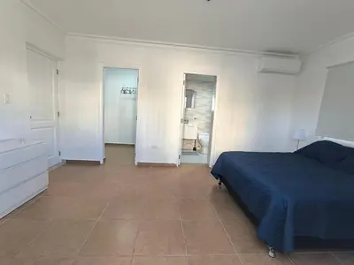 a bedroom with a blue bed and a tiled floor at Cana Esmeralda in Punta Cana