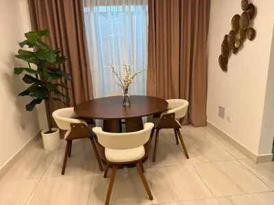 a dining room with a wooden table and chairs at Andrea Victoria in Santo Domingo