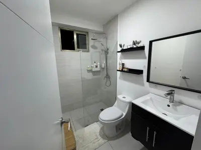 a bathroom with a toilet and a sink and a shower at Andrea Victoria in Santo Domingo