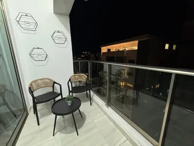 a balcony with chairs and a table on a building at Andrea Victoria in Santo Domingo