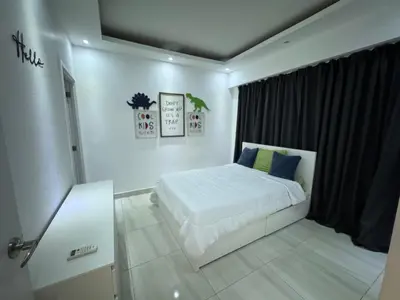 a white bedroom with a bed and a window at Andrea Victoria in Santo Domingo