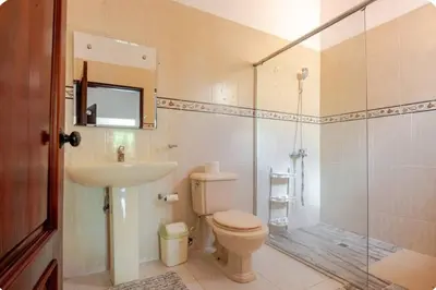 a bathroom with a toilet and a shower and a sink at Rio San Juan,Spacious,Local,3 Bedroom in Río San Juan