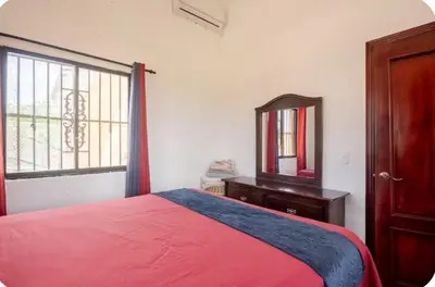 a bedroom with a bed and a dresser and a mirror at Rio San Juan,Spacious,Local,3 Bedroom in Río San Juan