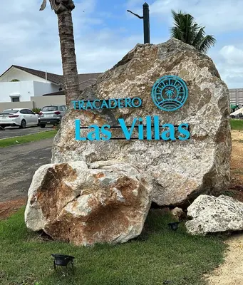 a sign for a las villas sign on a rock at VILLA CORAL Tracadero Beach Resort in La Laguna