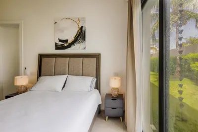 a bedroom with a bed and a large window at VILLA CORAL Tracadero Beach Resort in La Laguna