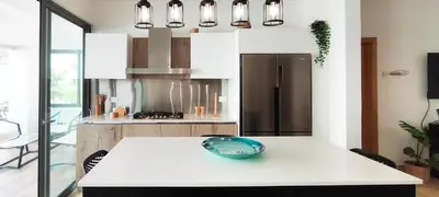 a kitchen with a white counter and a refrigerator at AMAR'E beach front apartment overlooking pool in Las Terrenas