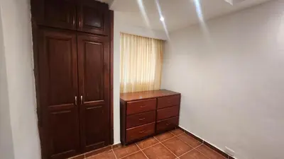 a bedroom with a wooden cabinet and a dresser at Essential Life La Cuaba Casa de Campo Amenities in Pedro Brand