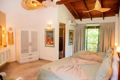 a bedroom with two beds and a window at Central Hotel Boutique in Las Galeras
