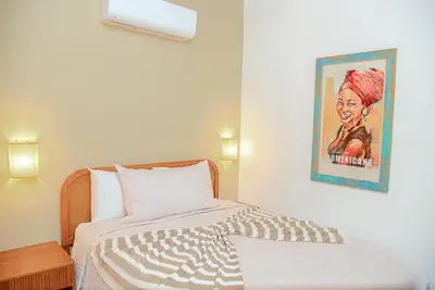 a bedroom with a bed with a painting on the wall at Central Hotel Boutique in Las Galeras