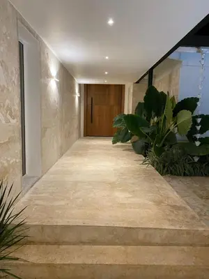 a hallway with stairs and plants in a building at Villa Allegria Los Lagos 57 in La Romana
