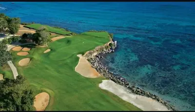 an aerial view of a golf course next to the ocean at Villa Allegria Los Lagos 57 in La Romana