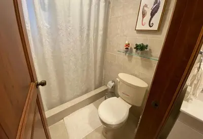 a small bathroom with a toilet and a shower at FreshBreeze - Apartment Near US Embassy in Santo Domingo