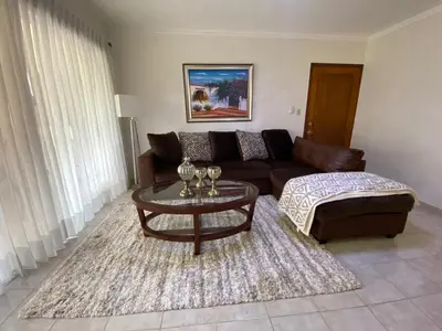 a living room with a couch and a coffee table at FreshBreeze - Apartment Near US Embassy in Santo Domingo