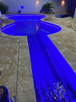 a swimming pool with blue water in a house at Villa Gordon in Santa Cruz de Barahona