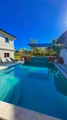 a large swimming pool with blue water at Villa anastacia in Sabaneta de Yásica