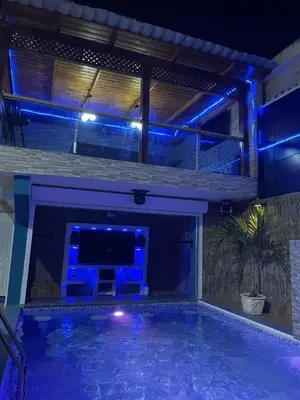 a swimming pool at night with blue lights at Acogedora Casa Vacacional in Colorado