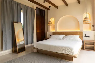 a bedroom with a white bed and a large window at Casa Sharon in El Valle