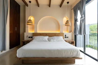 a bedroom with a large white bed and a balcony at Casa Sharon in El Valle