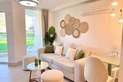 a living room with a couch and a table at Paraíso Soleado, apartamento en la playa in Sampiño