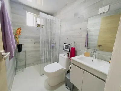 a bathroom with a toilet and a sink at 3BR & Rooftop Jacuzzi Near Beach in Las Terrenas