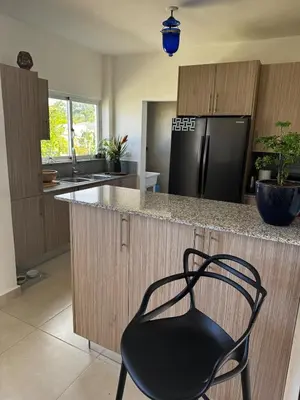 a black chair sitting at a counter in a kitchen at 3BR & Rooftop Jacuzzi Near Beach in Las Terrenas