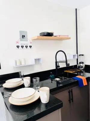 a kitchen counter with white plates and a sink at cerca de los mejores restaurantes I TV l Wifi in Constanza