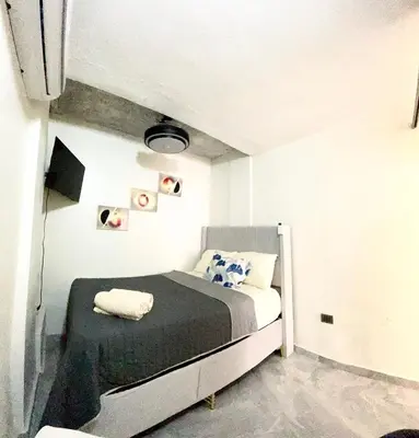 a bedroom with a bed in a white room at cerca de los mejores restaurantes I TV l Wifi in Constanza