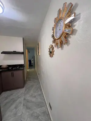 a clock is on the wall of a hallway at cerca de los mejores restaurantes I TV l Wifi in Constanza