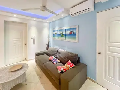 a living room with a couch and a table at Garden Condo, Sosua in Sosúa