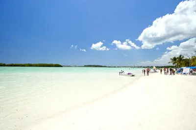 a group of people standing on a white beach at Hannabi in Colorado