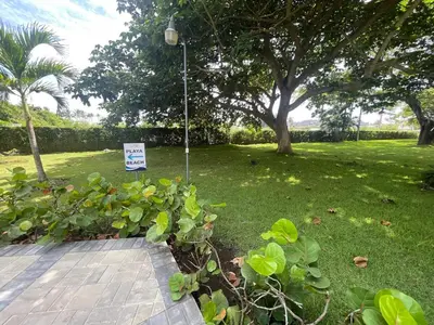a sign in a park with a sign in the grass at Luxury apartment Playa Dorada in Puerto Plata