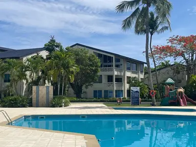 a resort with a swimming pool in front of a building at Luxury apartment Playa Dorada in Puerto Plata