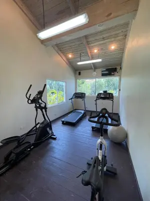 a gym with three exercise bikes in a room at Luxury apartment Playa Dorada in Puerto Plata