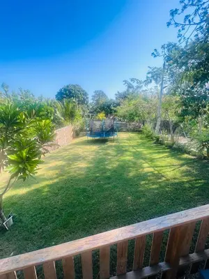 a large yard with a playground in the background at Villa para grupos in Concepción de La Vega