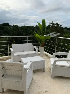 a group of chairs and tables on a balcony at Villa para grupos in Concepción de La Vega