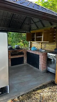 an outdoor kitchen with a counter and a stove at Villa para grupos in Concepción de La Vega