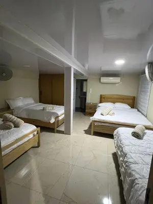 a room with three beds in a room at Villa para grupos in Concepción de La Vega