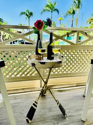 a table with two bottles of wine and a rose at Las Terrenas La Dolce Vita 7, Captivating and Exciting in Las Terrenas