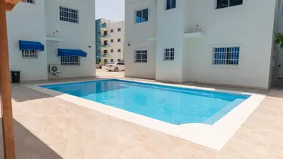 a swimming pool in front of a building at Agua Azul Boca Chica Accommodation in Andrés