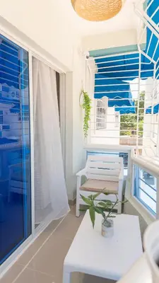 a living room with a bench and a large window at Agua Azul Boca Chica Accommodation in Andrés