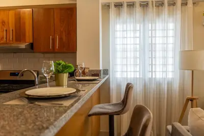a kitchen with a counter with wine glasses on it at Apartment in Santo Domingo in Santo Domingo