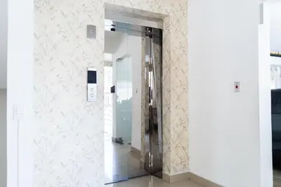 a hallway with a glass elevator in a building at Apartment in Santo Domingo in Santo Domingo