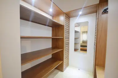 a walk in closet with wooden shelves and a mirror at House with pool 300 m from Las Ballenas beach in Las Terrenas